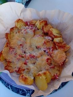 some food is sitting in a paper bowl