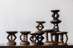 an assortment of wooden stools sitting on top of a table