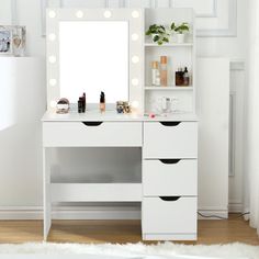 a white vanity with lights on it in a room