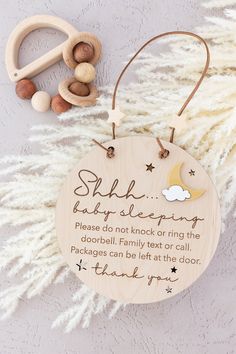 a wooden ornament with a poem on it and some beads next to it