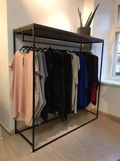 a clothes rack with several shirts hanging on it