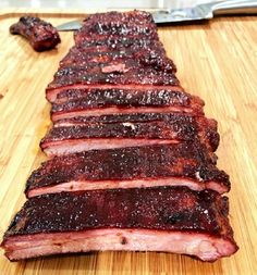 sliced meat sitting on top of a wooden cutting board