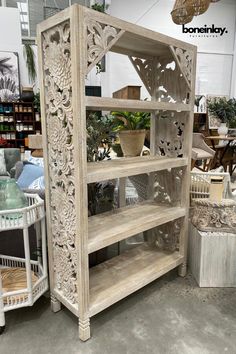 a white wooden shelf sitting inside of a store