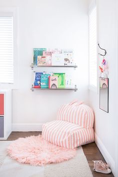 a child's bedroom with pink and white decor