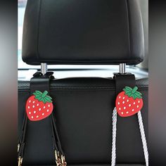 two strawberries are attached to the seat belt