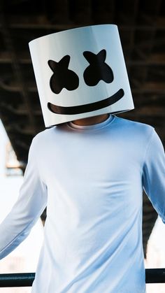 a person wearing a paper hat with eyes and nose