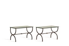 a pair of tables with glass tops on each side and metal legs in the middle