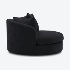 a black chair with pillows on top of it