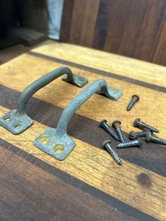 an assortment of screws and nuts on a wooden table