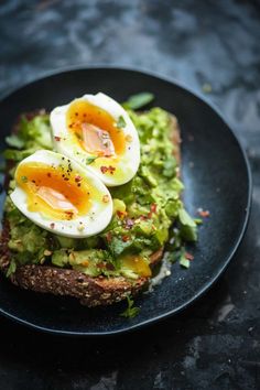 an open face sandwich with hard boiled eggs and avocado on toasted bread