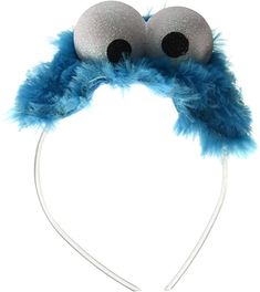 a close up of a headband with two eyes and a fuzzy ball on it