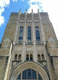 the front entrance to an old church with blue sky in the background and clouds in the foreground