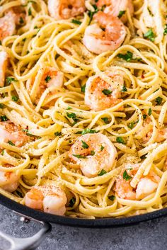 pasta with shrimp and parsley in a skillet ready to be served on the table