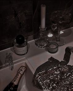 a black and white photo of a sink with some accessories on the counter next to it