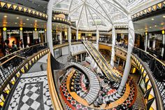 the interior of a shopping mall with multiple floors and spiral staircases, as seen from above