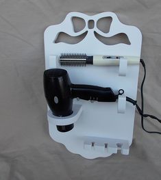 a hair dryer, blowdryer and other items are displayed on a white board