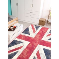 a flag rug is in the middle of a room with white cupboards and drawers