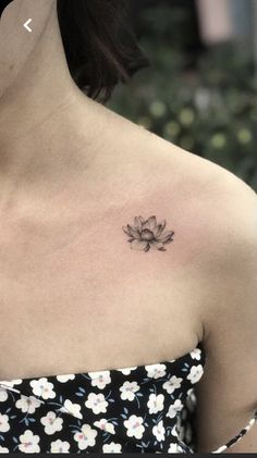 a woman with a flower tattoo on her chest