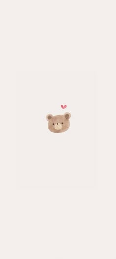 a brown teddy bear with a pink heart on its nose in the middle of a white wall