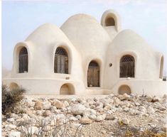 an unusual building with two arched windows on the outside