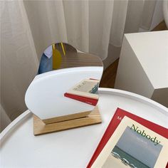 a white table topped with a magazine and pictures