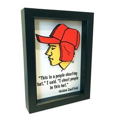 a paper cut out of a man wearing a red hat with the quote, this is a people shooting hat i said it'd shoot people in the hat