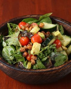 a salad in a wooden bowl on a table