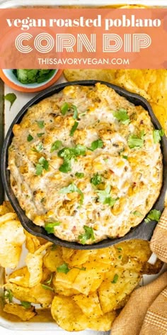 an overhead view of a corn dip in a cast iron skillet with tortilla chips on the side