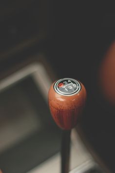 a close up of a steering wheel knob with a red and white button on it