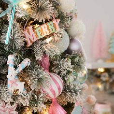 a christmas tree decorated with ornaments and candy canes in pastel colors is shown