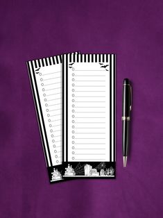 two black and white striped notebooks next to a pen on a purple cloth background