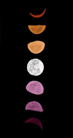 five different colored circles are arranged in the shape of a moon on a black background