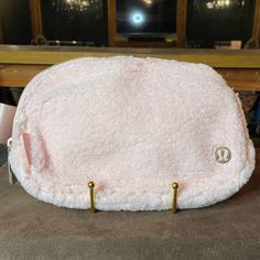 a pink purse sitting on top of a table