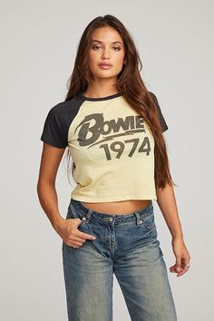 a woman wearing jeans and a t - shirt with the words bowling 1974 on it