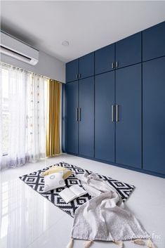 a room with blue cabinets and white flooring