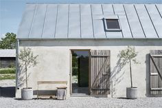 a small house with a metal roof and windows