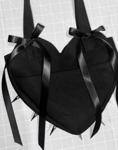 a heart shaped bag with black ribbon tied around it