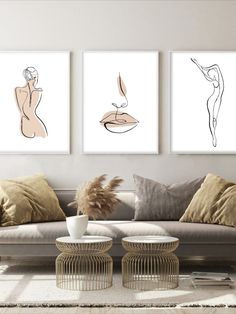 three framed art prints on the wall above a couch