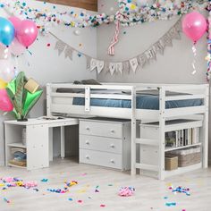 a white bunk bed sitting in a bedroom next to a desk with drawers under it