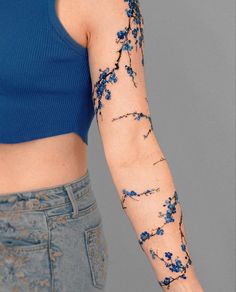 a woman's arm with blue flowers on it