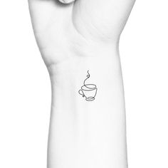 a hand with a coffee cup tattoo on it