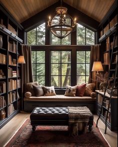 a living room filled with lots of furniture and bookshelves next to a window