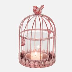 a pink bird cage with a candle inside