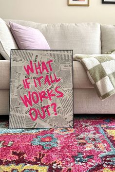 a living room with a couch, rug and pictures on the wall