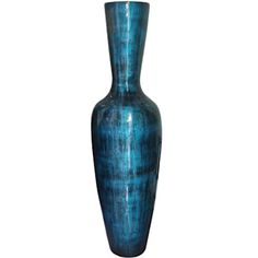 a tall blue vase sitting on top of a table