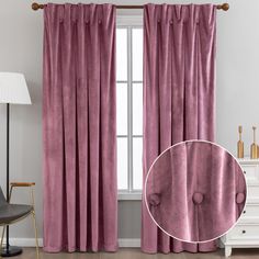 the curtains in this living room are pink and have buttons on them, along with a black chair