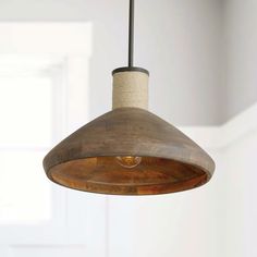 a wooden light fixture hanging from a ceiling in a room with white walls and flooring