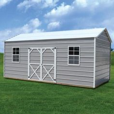 a small metal storage shed in the middle of a grassy field