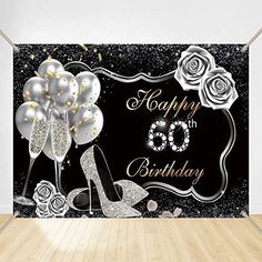 a black and white birthday backdrop with high heeled shoes, roses and sparkles