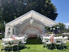 tables and chairs are set up under a tent